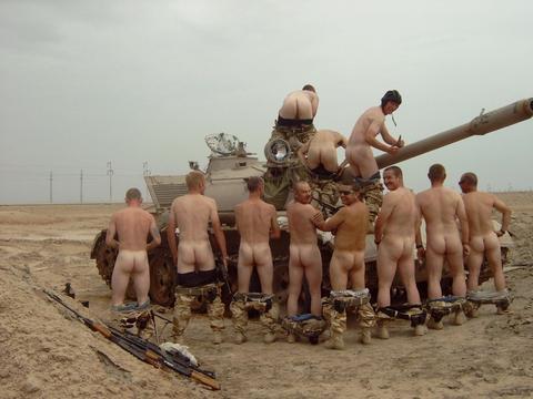 Naked soldiers clustered around a tank